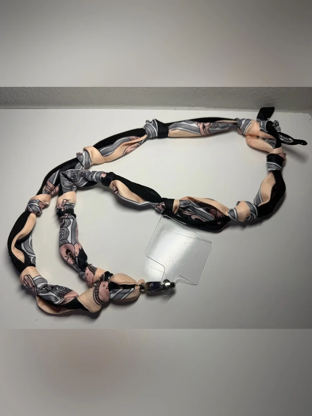 Silk-Twilly Pink and Black tied onto a leather lanyard holder/cell phone cord.